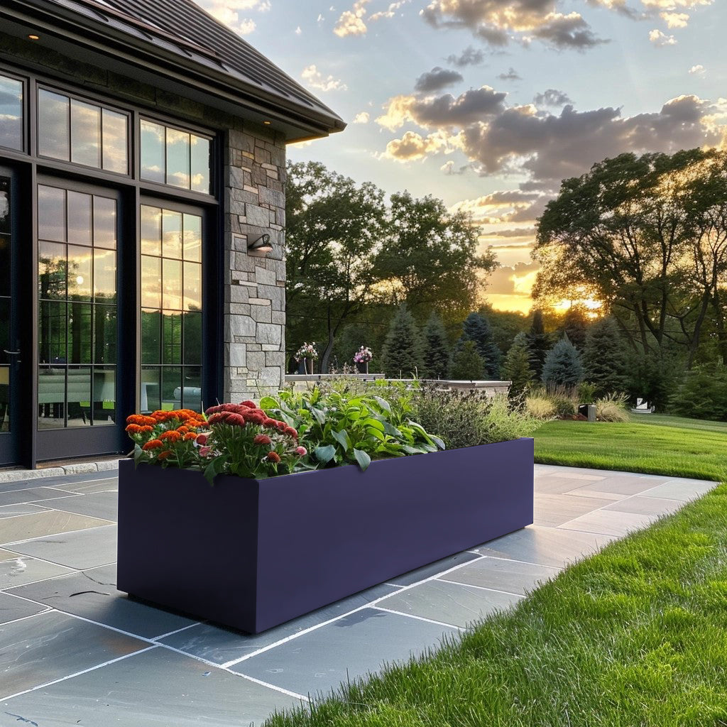 Metal planter and modern house. Long power coated rectangular steel planter thick gauge high quality welded in America USA made craftsman bespoke in the backyard of a modern farmhouse. Rusted metal planter stone house. Purple powercoated planter stone house