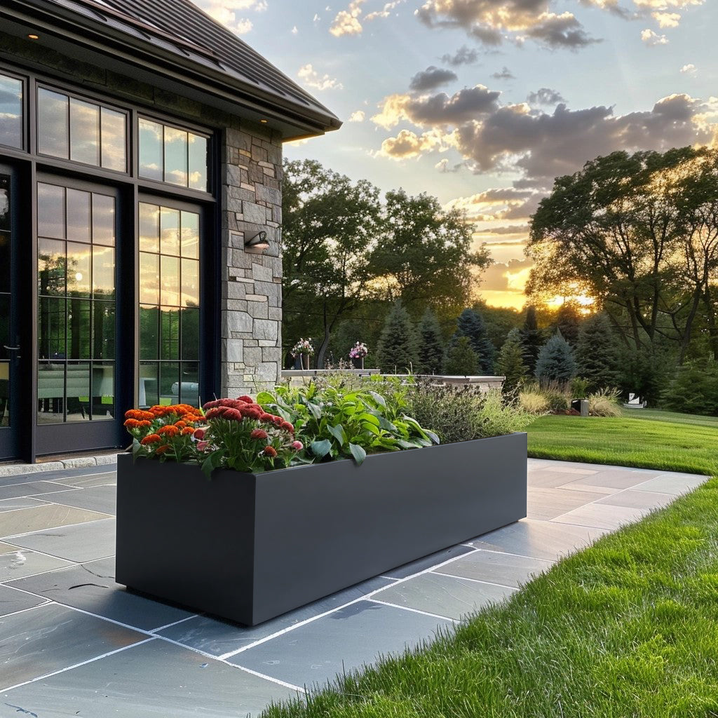 Metal planter and modern house. Long power coated rectangular steel planter thick gauge high quality welded in America USA made craftsman bespoke in the backyard of a modern farmhouse. Rusted metal planter stone house.