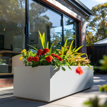 Metal planter and modern house. Long power coated rectangular steel planter thick gauge high quality welded in America USA made craftsman bespoke in the backyard of a modern farmhouse. 