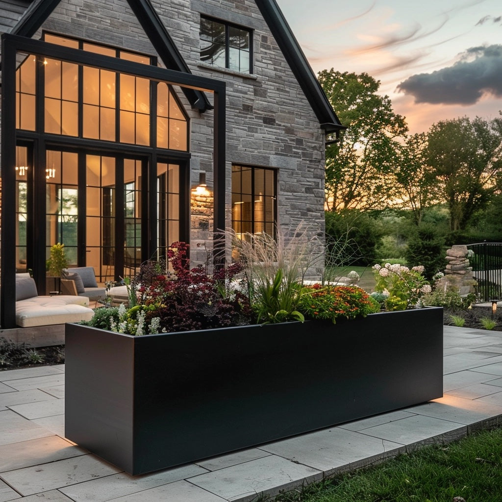 Metal planter and modern house. Long power coated rectangular steel planter thick gauge high quality welded in America USA made craftsman bespoke in the backyard of a modern stone house. Metal planter large backyard.